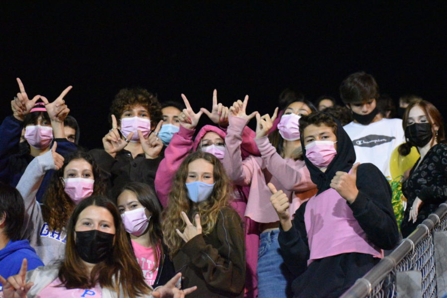 Cleveland students in the bleachers at the homecoming soccer game wearing pink for breast cancer awareness.